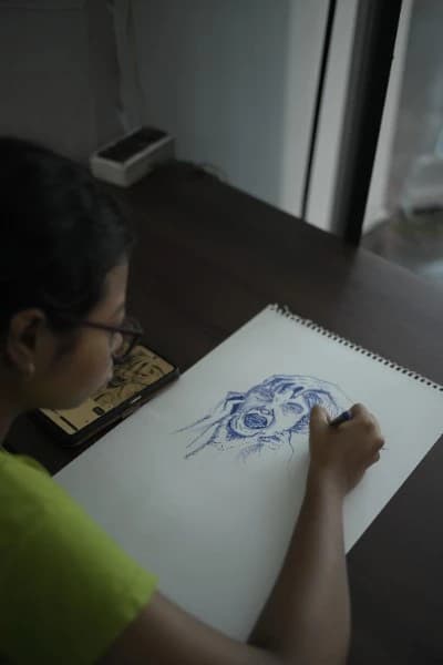 An artist sketching a portrait during an art activity
