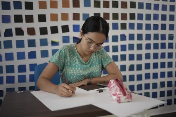 An artist sketching a portrait during an art activity